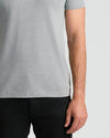 Person wearing Classic Crew Neck T-shirt over black pants.