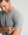 Man adjusting sleeve of Heather Gray Classic Crew Neck T-shirt.