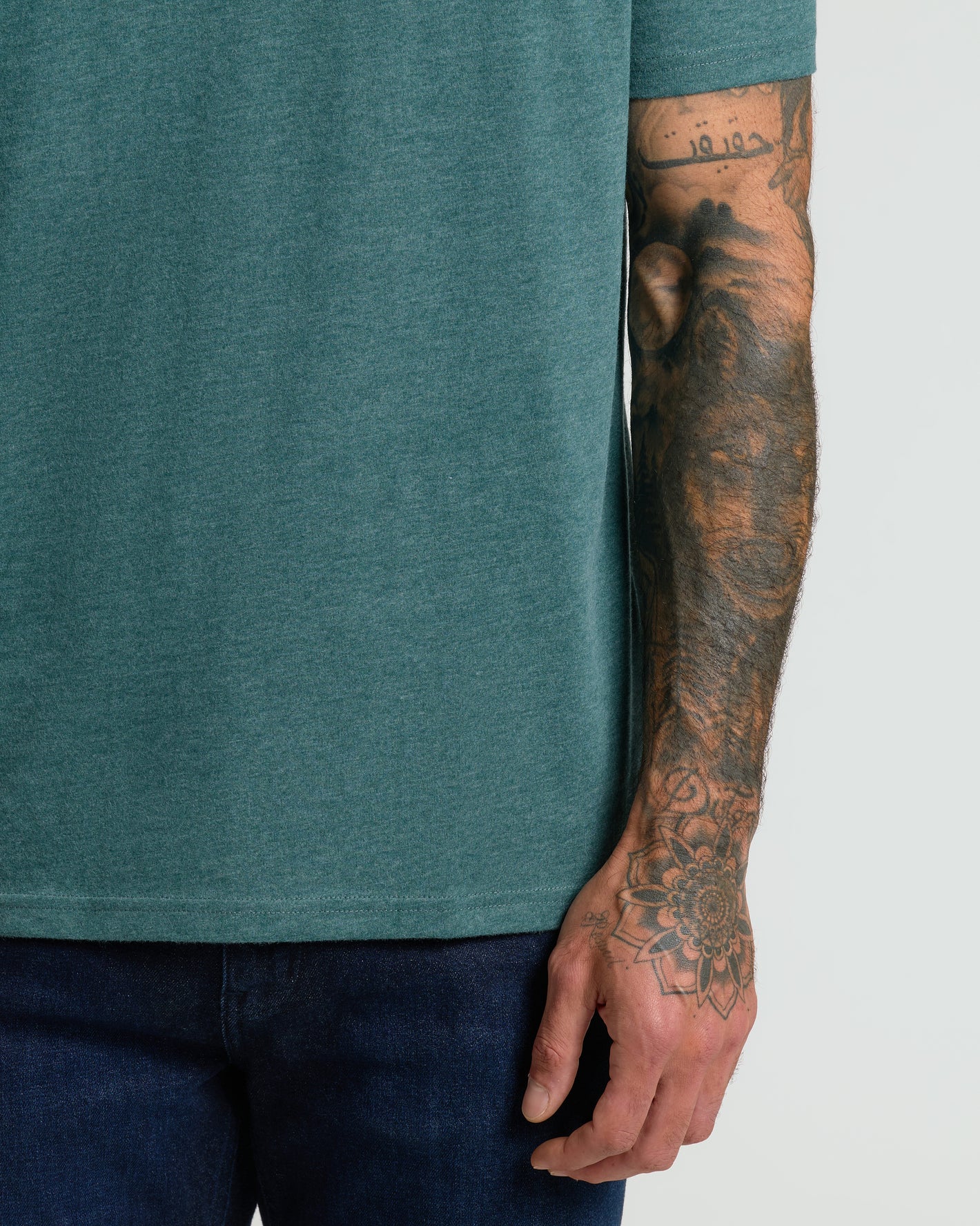 Heather Seafarer Classic Crew Neck showcasing fit and tattooed arm.