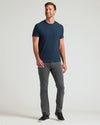 Man in navy Classic Crew 10-Pack T-shirt, gray jeans, black sneakers.