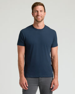 True ClassicMan in The Staple Classic Crew Neck 3-Pack, blue T-shirt, gray pants.