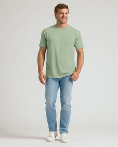 True ClassicMan wearing a green t-shirt and light blue jeans on a white background