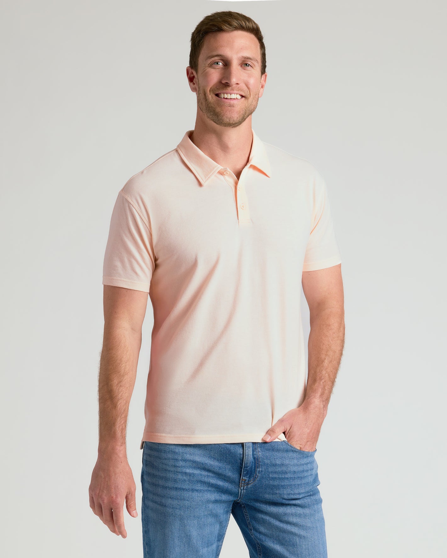 Man wearing Limited Short Sleeve Classic Polo 3-Pack in pale peach.