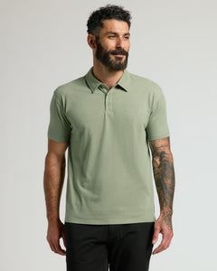 True ClassicMan wearing Dark Heather Bay Green Classic Polo with tattoos visible.