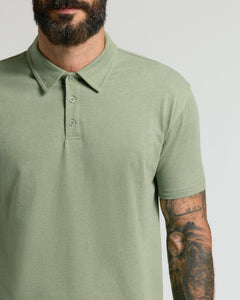 True ClassicMan wearing Dark Heather Bay Green Classic Polo with tattooed arm.
