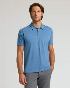 True ClassicMan wearing Dark Heather Blue Lake Classic Polo and gray trousers.