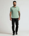 Man wearing Heather Slate Green Classic Polo, black trousers, and dress shoes.