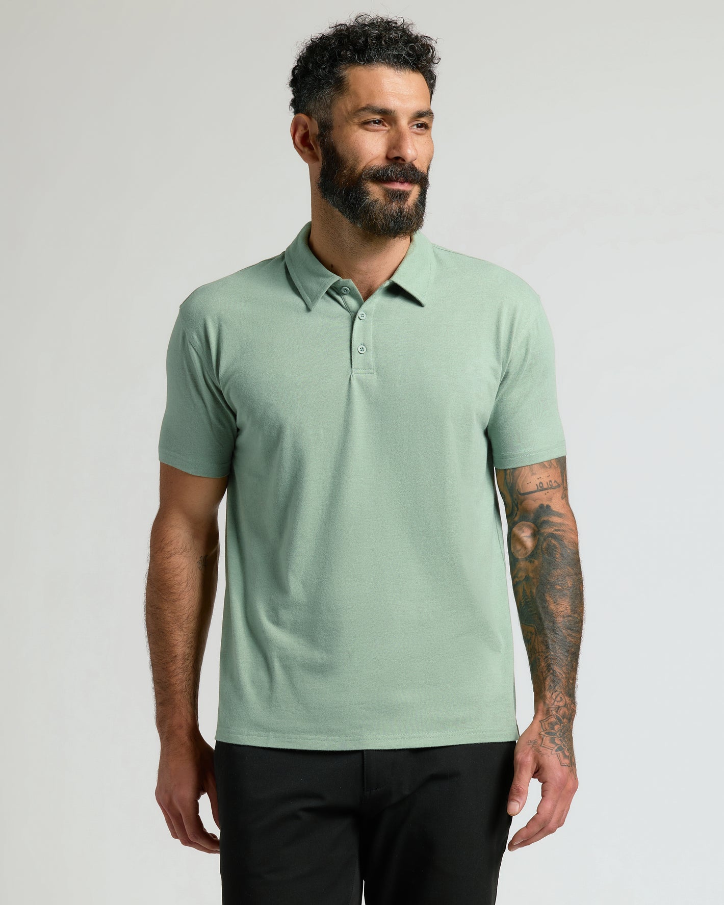 Heather Slate Green Classic Polo on male model with tattoos.