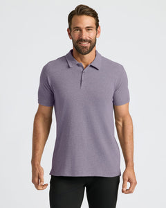 True ClassicMan wearing Dark Heather Amethyst Short Sleeve Polo, smiling slightly.