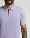 Man wearing Heather Dark Orchid Short Sleeve Polo, showcasing tattooed forearm.
