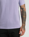 Heather Dark Orchid Short Sleeve Polo worn with tattooed arm visible.