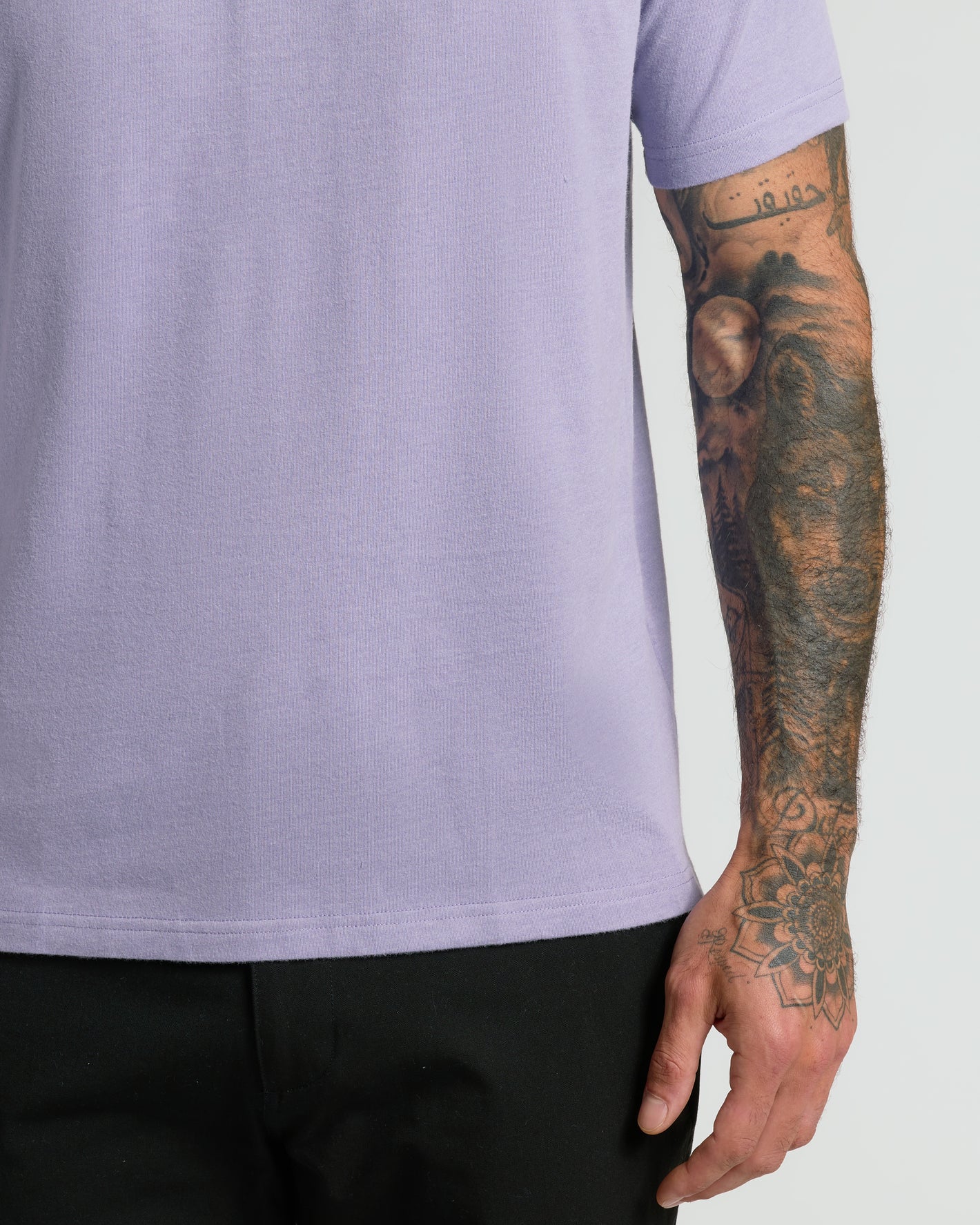 Heather Dark Orchid Short Sleeve Polo worn with tattooed arm visible.