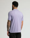 Man wears Heather Dark Orchid Short Sleeve Polo, showcasing tattooed arm.