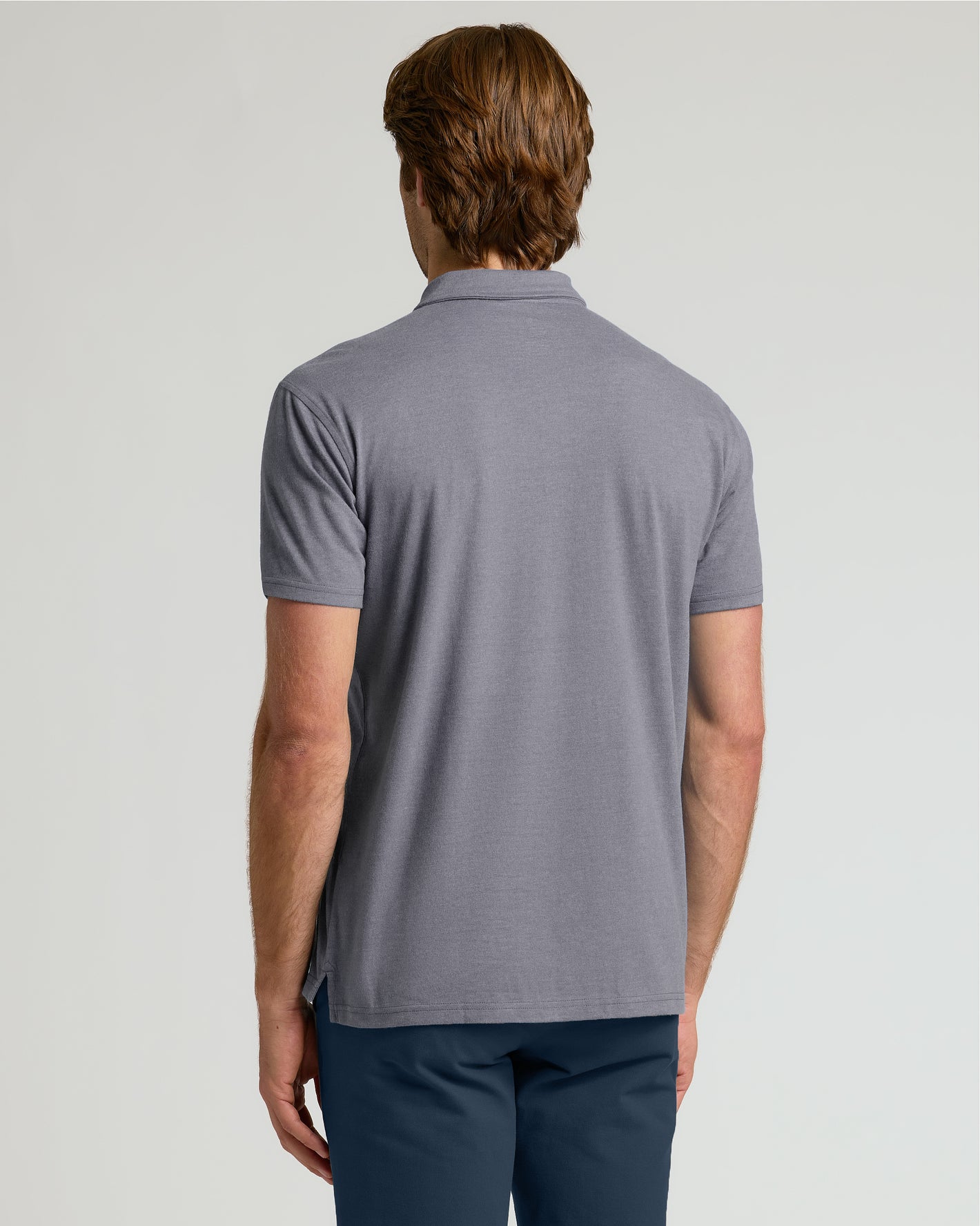 Heather Graphite Short Sleeve Polo worn by man from behind.
