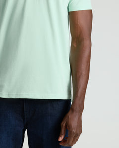 True ClassicHeather Mist Short Sleeve Polo worn with dark blue pants.