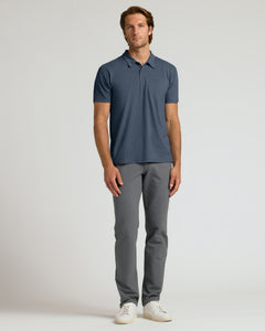 True ClassicMan wearing a blue polo shirt and gray pants on a light gray background