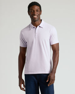 True ClassicMan in Heather Orchid Classic Polo and dark jeans smiling.