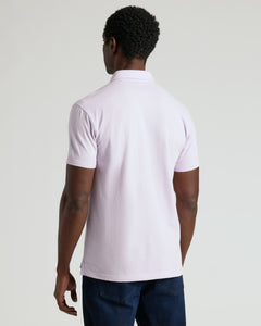 True ClassicMan wearing Heather Orchid Classic Polo, back view, against light background.