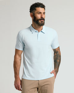 True ClassicMan wearing Icicle Classic Polo with tattooed arm, looking right.
