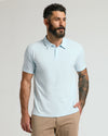 Man wearing Icicle Classic Polo with tattooed arm, looking right.