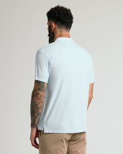 True ClassicMan wearing Icicle Classic Polo with tattooed arm visible.