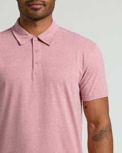 True ClassicMan wearing Light Heather Boysenberry Classic Polo, showcasing tattoos and button details.
