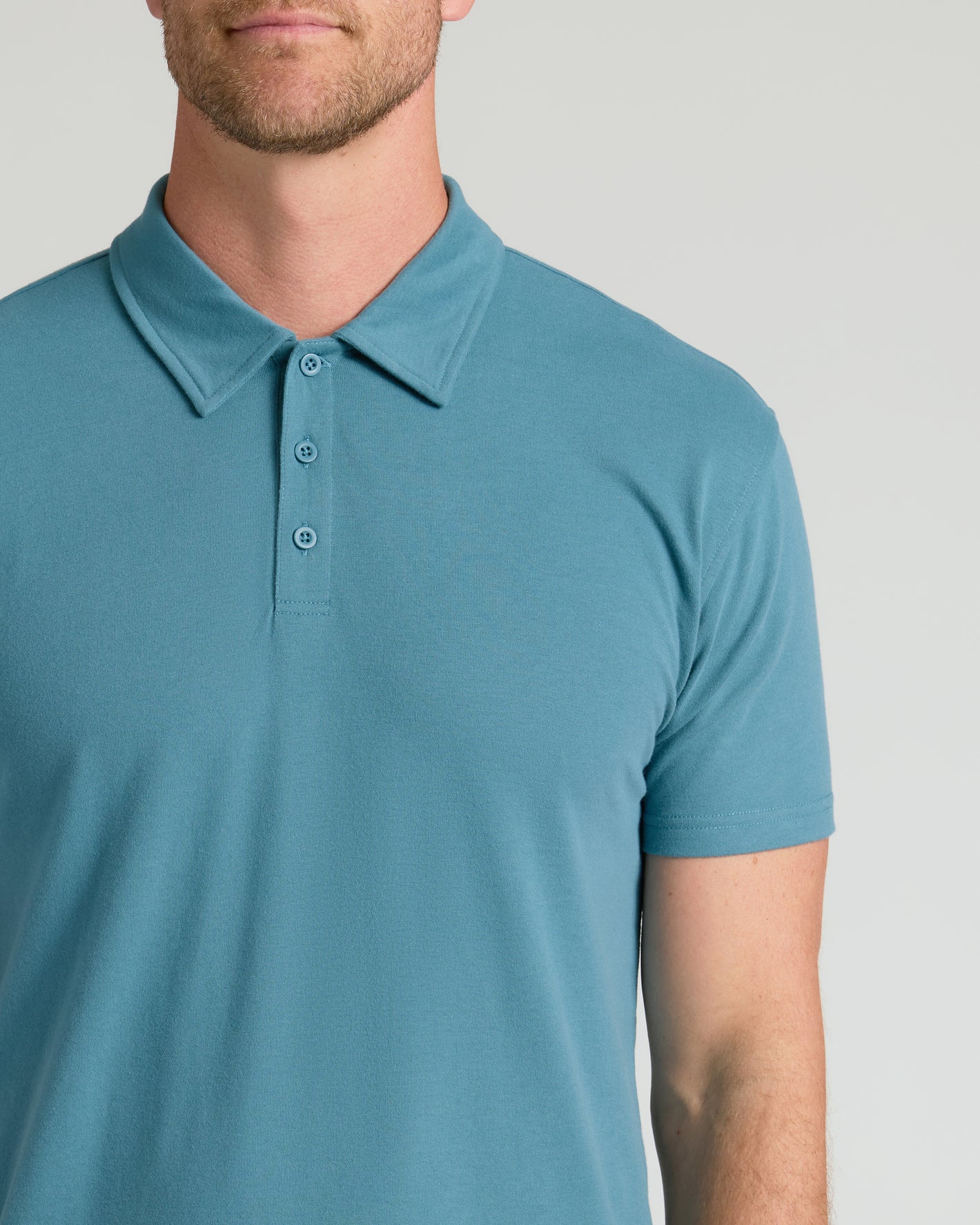 Man wearing Sapphire Classic Polo, showcasing its fitted, short-sleeve style.