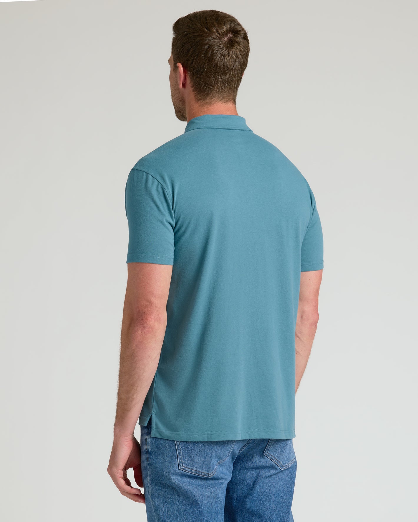 Sapphire Classic Polo on man, back view, paired with jeans.
