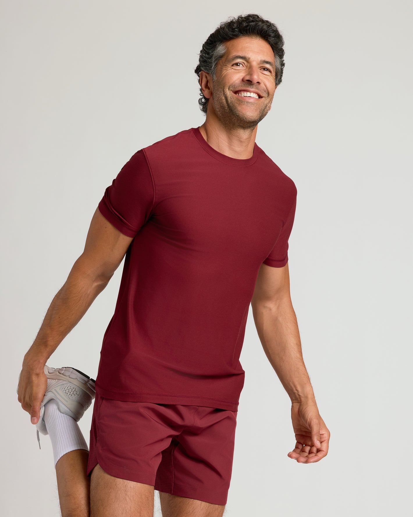 Man stretching in Auburn Active Crew Neck Tee.