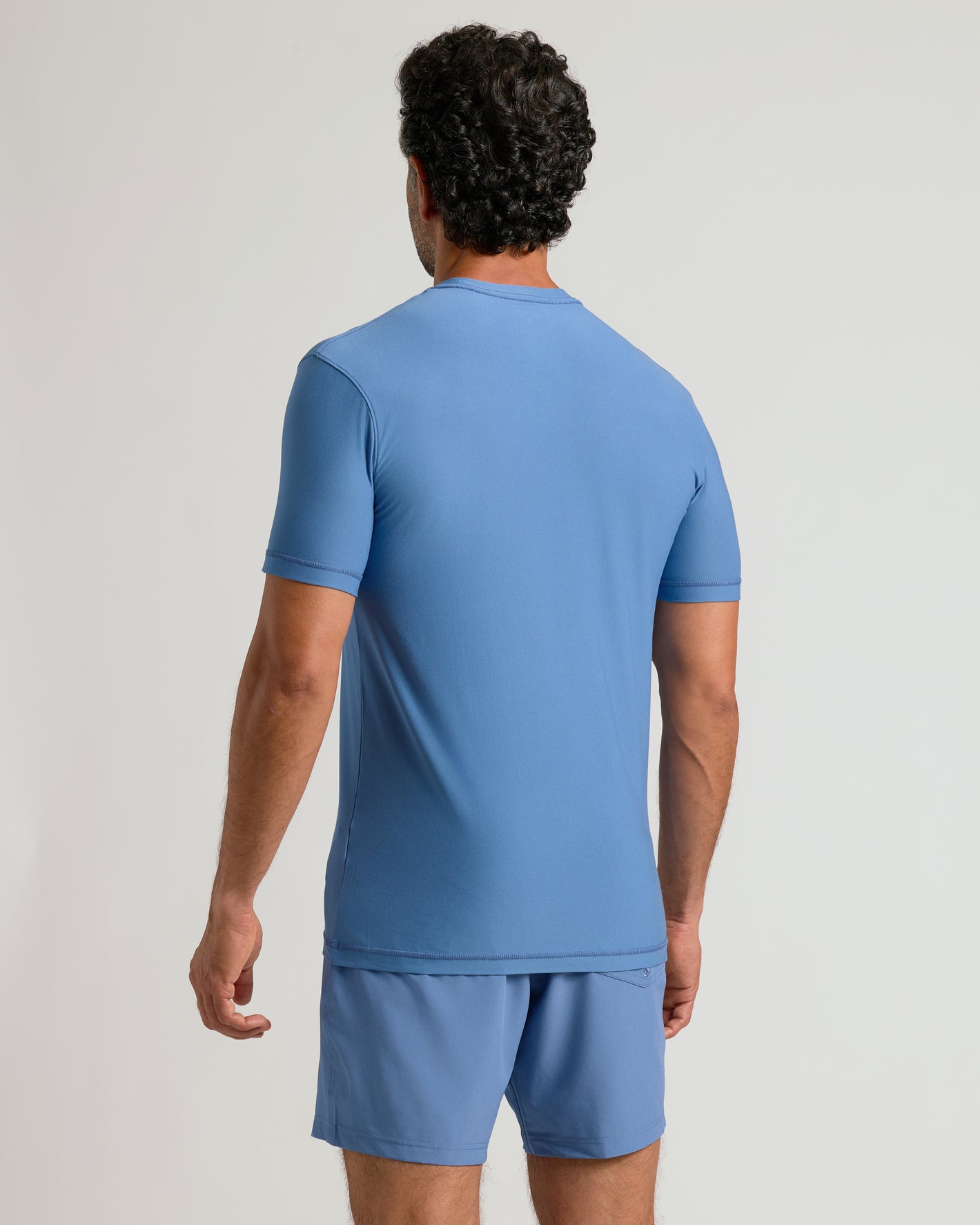 Man wearing Azul Active Crew Neck Tee and shorts, back view.
