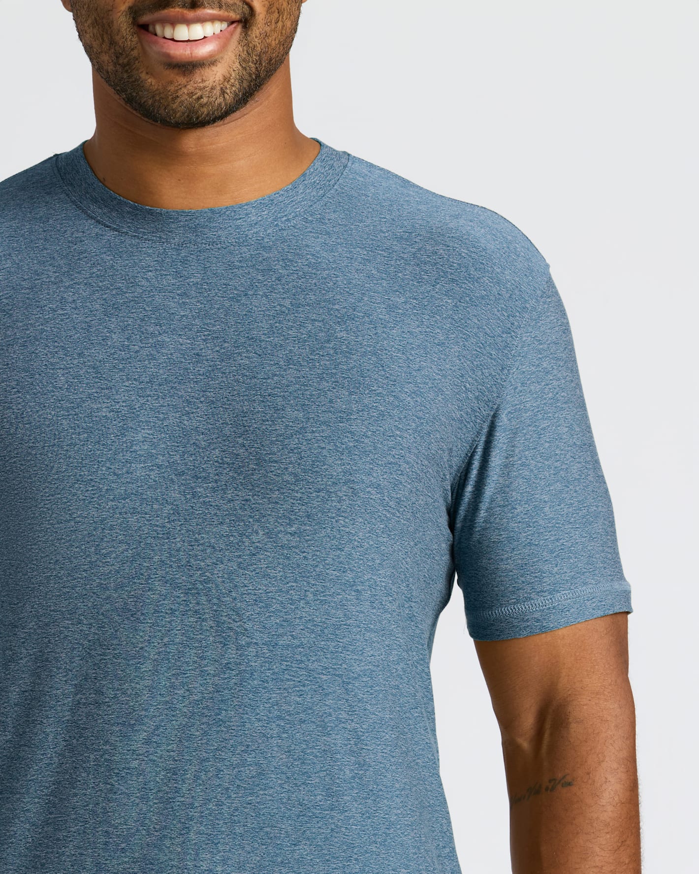 Close-up of a man wearing a Baltic Active Crew Neck Tee in a soft blue color, showcasing the comfortable fit and casual style of this men's basics essential.
