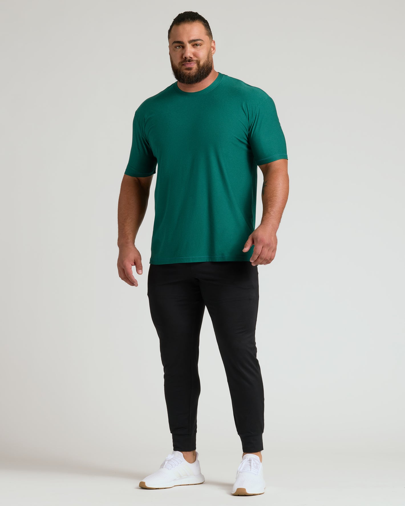 Clover Active Crew Neck Tee on athletic man, relaxed pose.