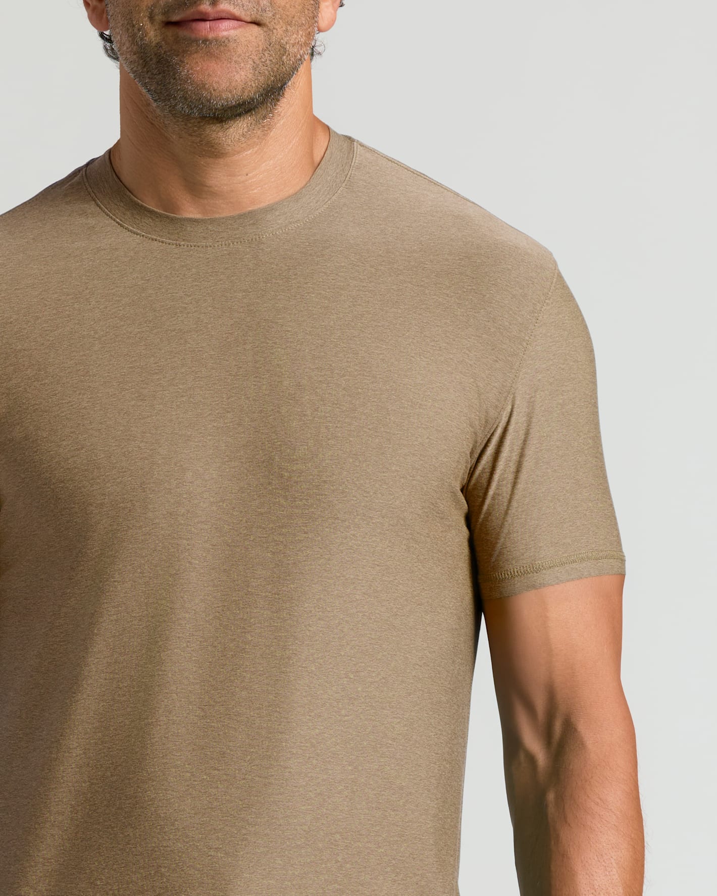Man wearing a brown short-sleeve Driftwood Active Crew Neck Tee, showcasing a comfortable fit and classic crew neck design in a men's basics style.