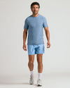 Man wearing Heather Azul Active Crew Neck Tee with matching athletic shorts.