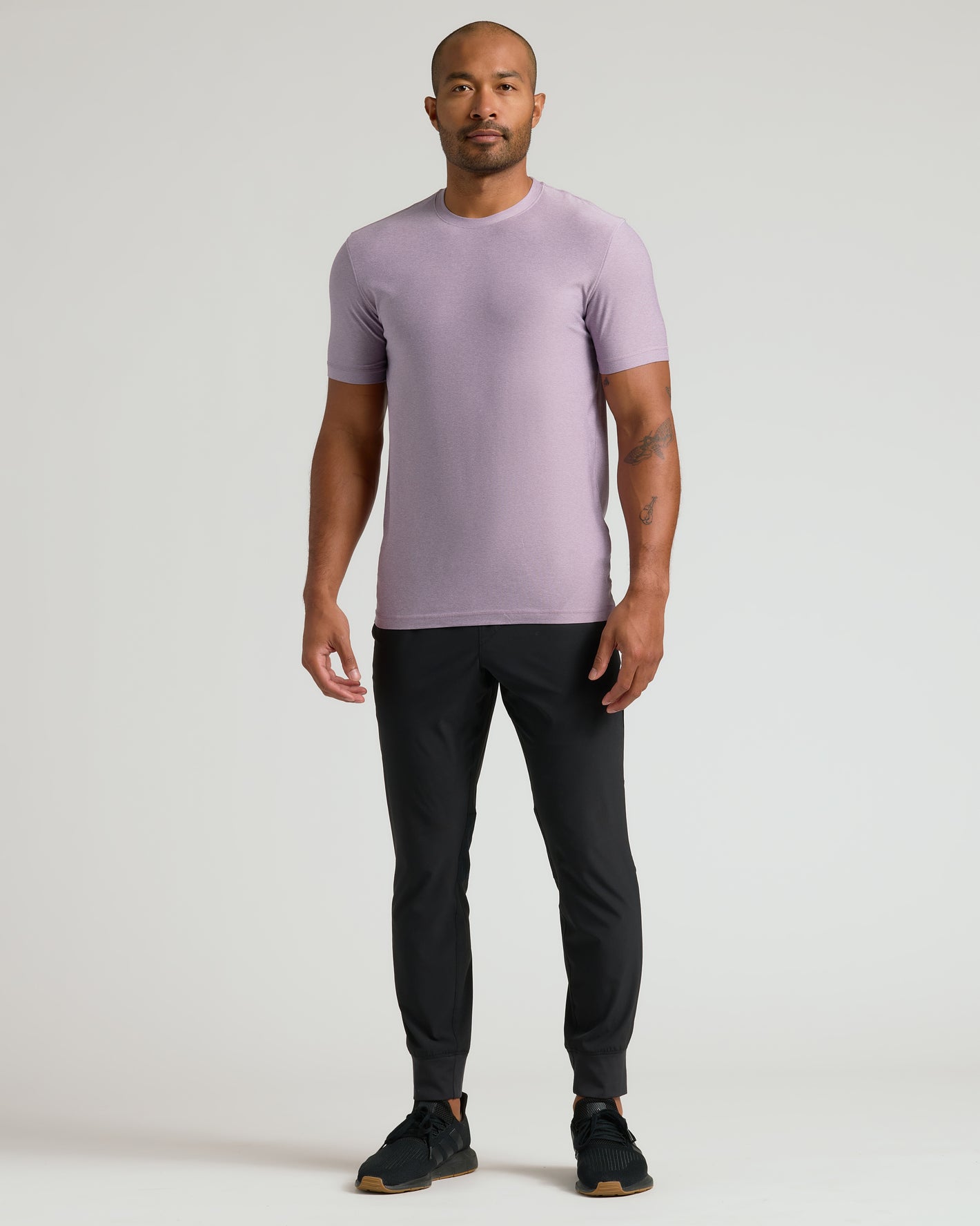 Male model in Iris Active Crew Neck Tee with black joggers.