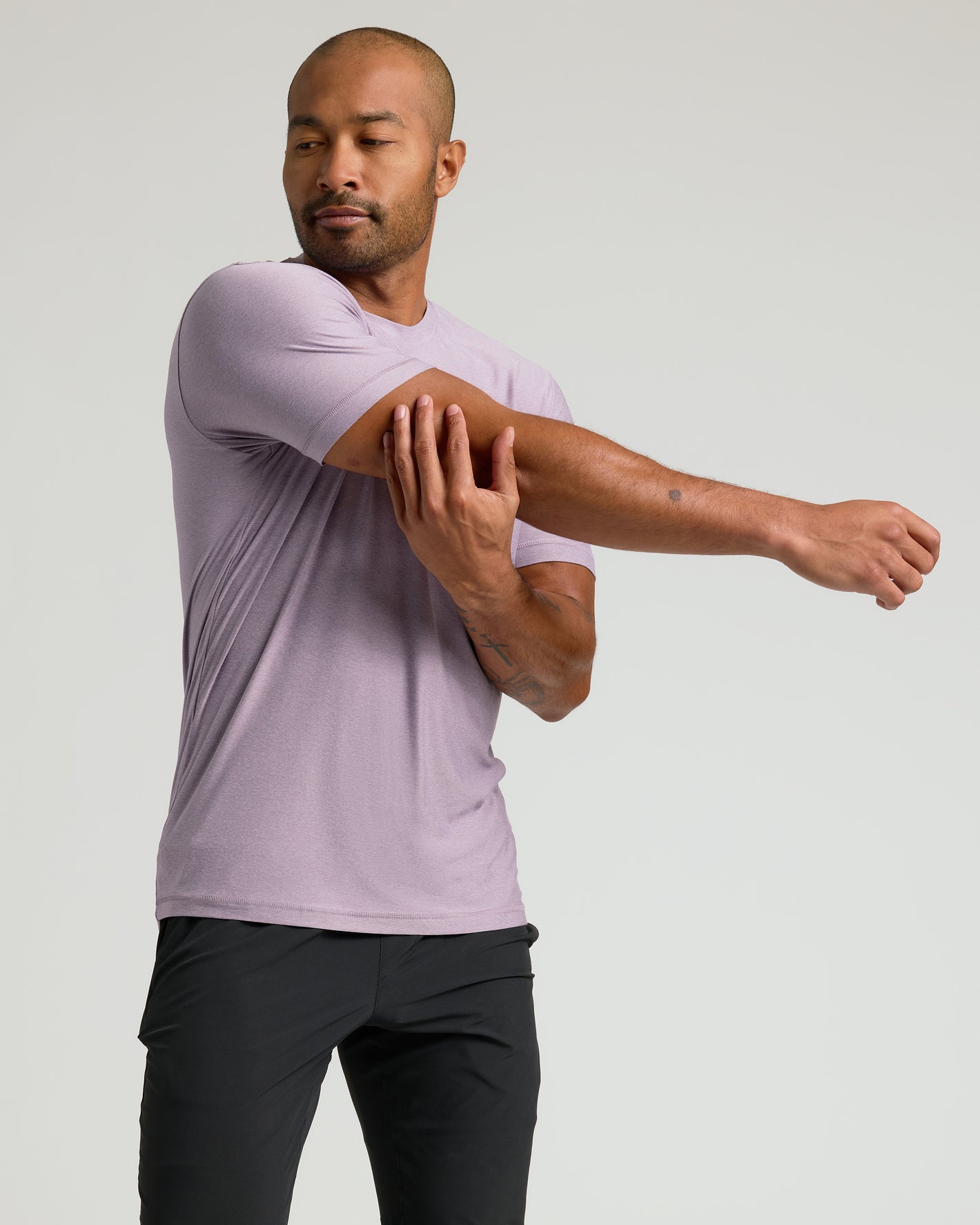 Man stretching in Iris Active Crew Neck Tee.