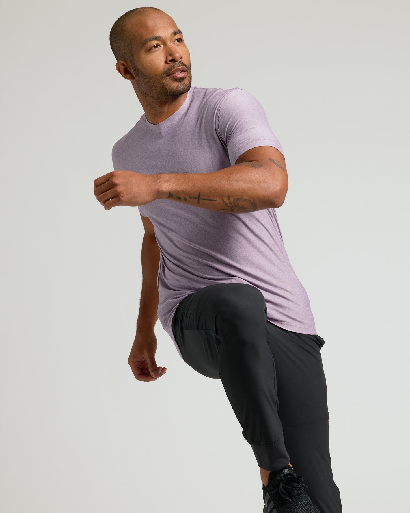 Man wearing Iris Active Crew Neck Tee, demonstrating its flexibility.