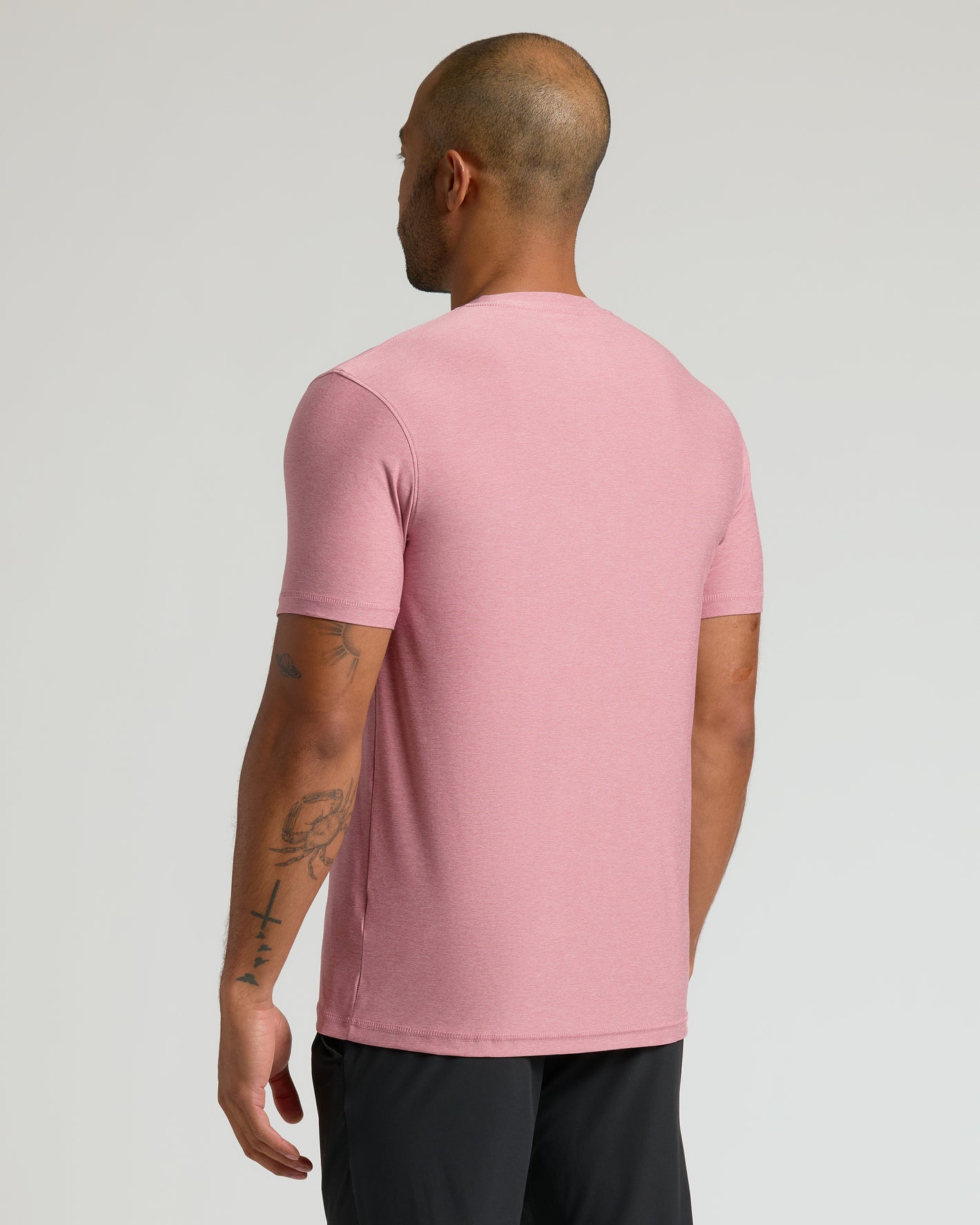 Quartz Rose Active Crew Neck Tee, back view, tattooed arm visible.
