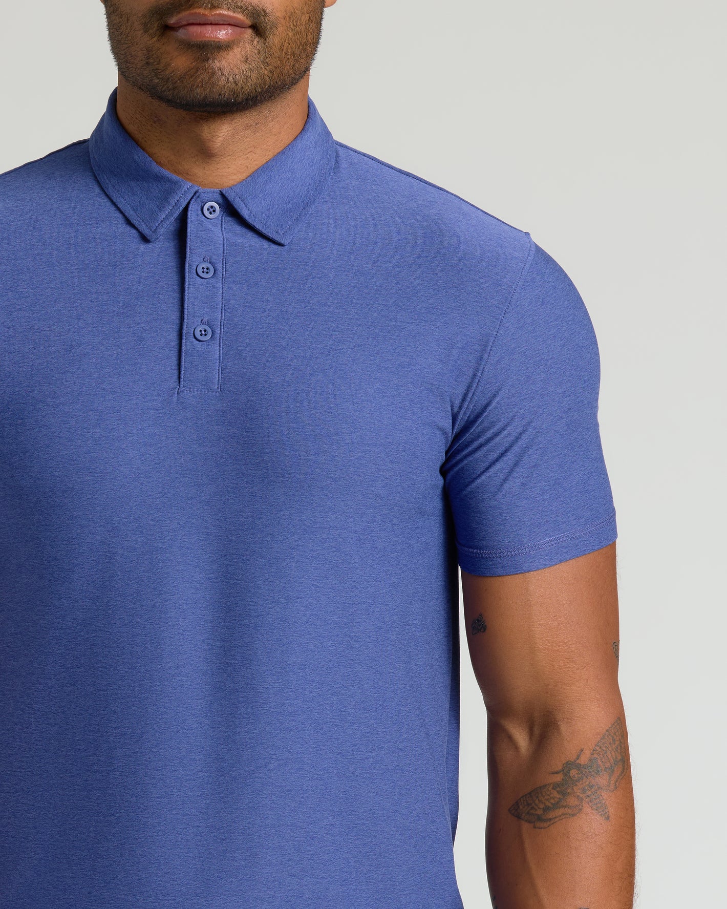 Cosmos Active Polo 2.0 worn by man with arm tattoos.