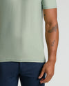 Lichen Active Polo 2.0 worn with tattoos visible on forearm.
