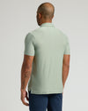 Lichen Active Polo 2.0, back view, showcasing tattoos and side slit.