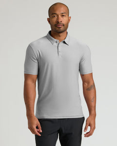 True ClassicMan wearing a Light Heather Gray Active Polo 2.0 with short sleeves and a three-button placket, standing against a neutral background.