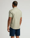 Back view of man in Fiord & Mossy Oak Short Sleeve Linen Shirt.