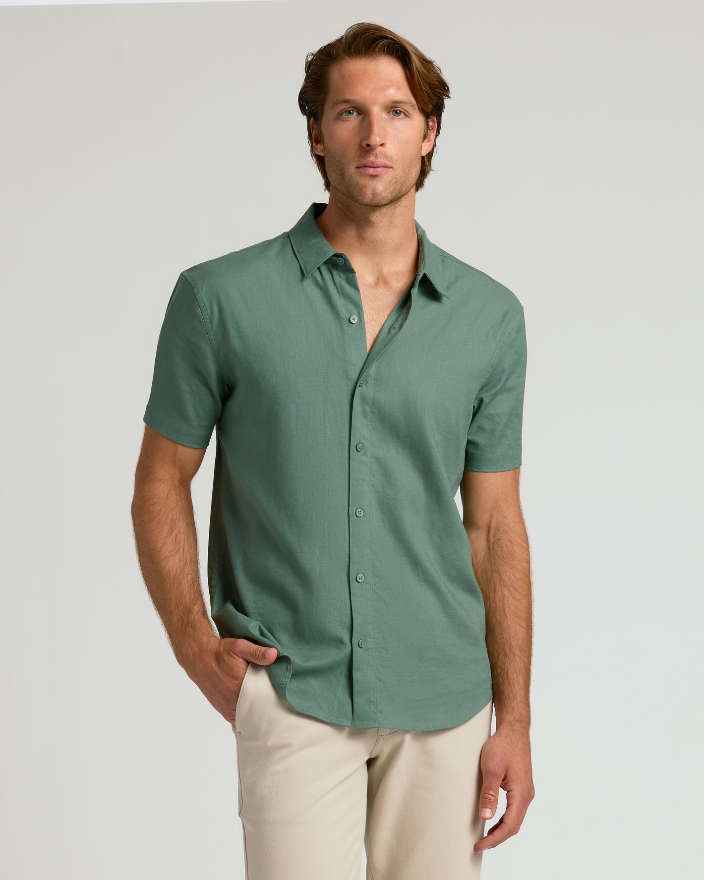 Model wearing Moss Short Sleeve Linen Shirt with beige trousers.