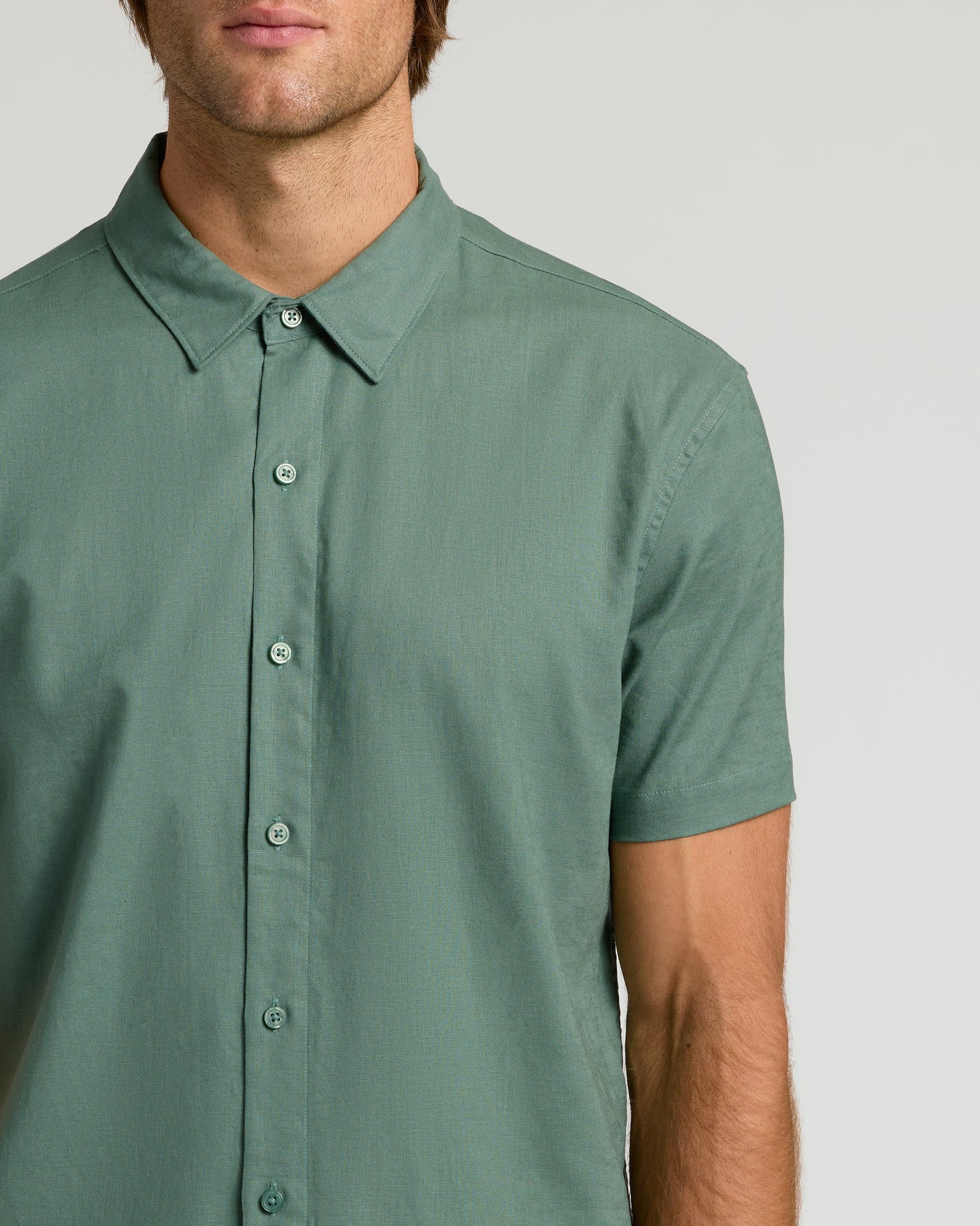 Moss Short Sleeve Linen Shirt on male model, emphasizing breathable, relaxed fit.