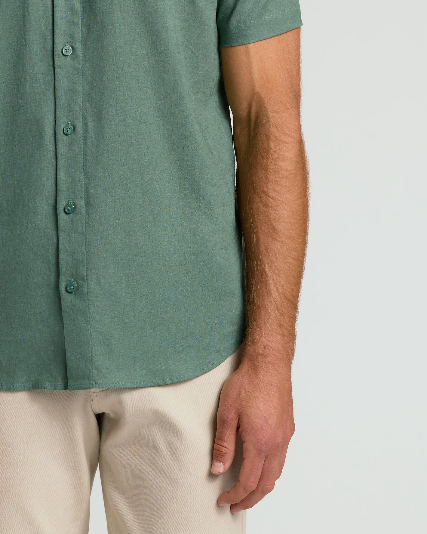 Moss Short Sleeve Linen Shirt worn with beige trousers.