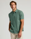 Man wears Moss Short Sleeve Linen Shirt with relaxed fit.