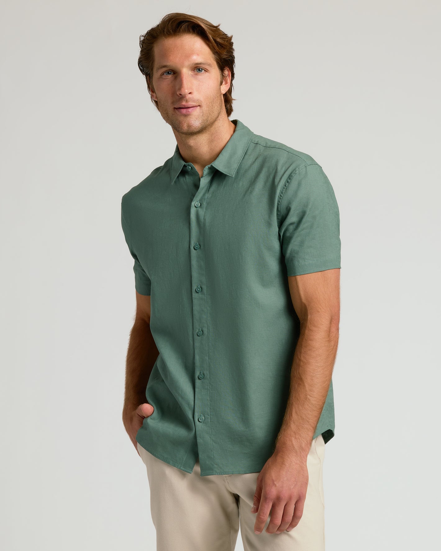 Man wears Moss Short Sleeve Linen Shirt with relaxed fit.