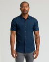 Male model in Navy Short Sleeve Linen Shirt, gray pants, neutral expression.