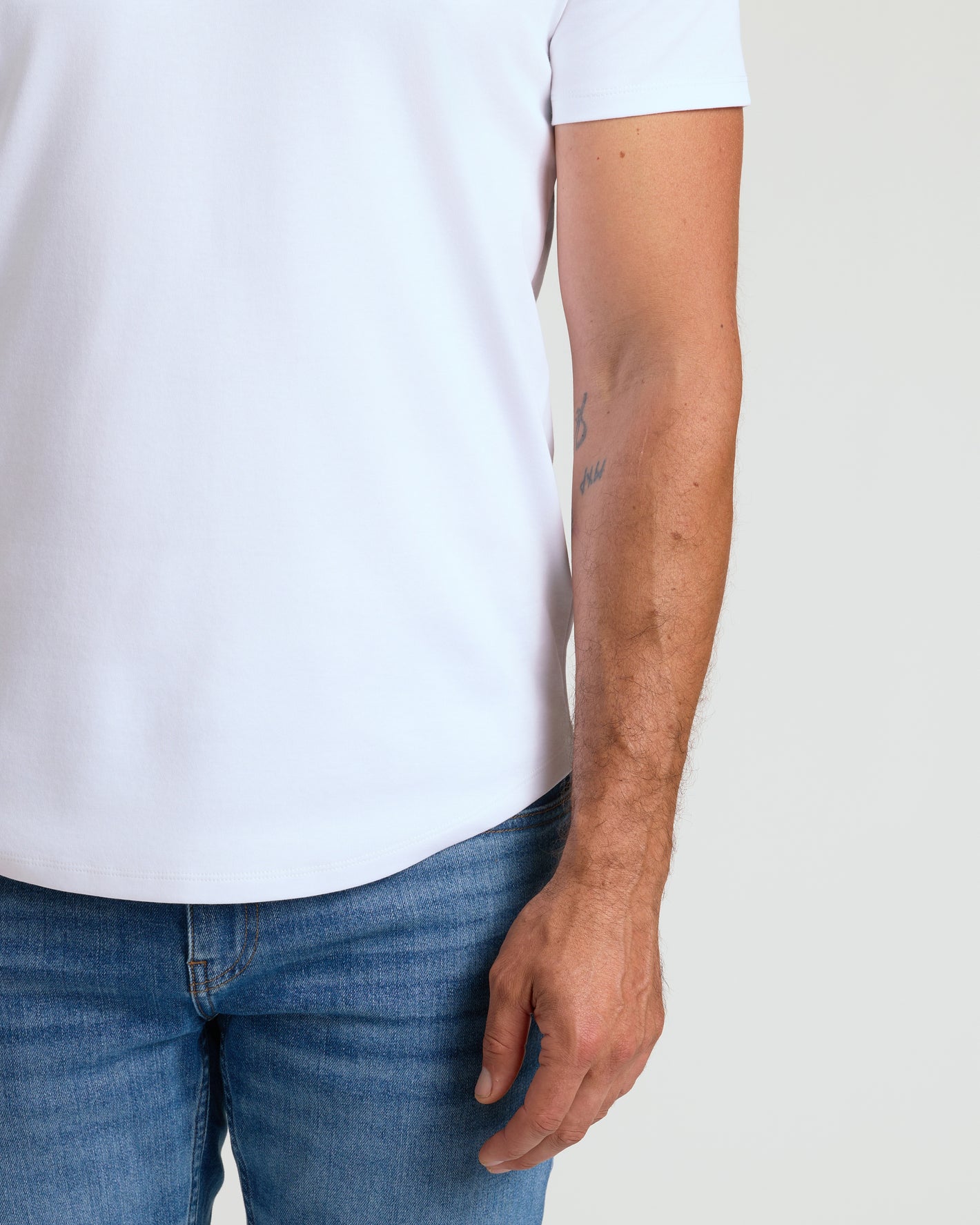 White Premium Pima Crew Curved Hem on person, showcasing tailored fit.